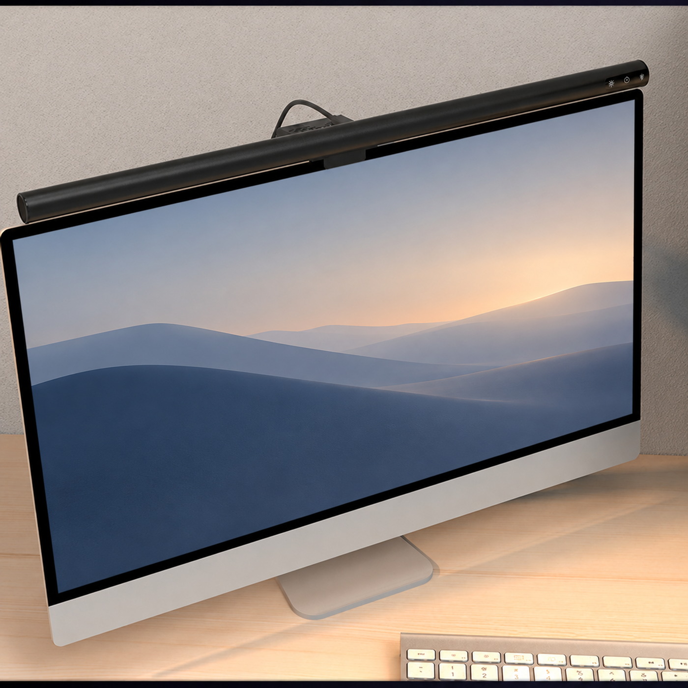Black LumenBar monitor light above a desktop monitor on a warmly lit desk